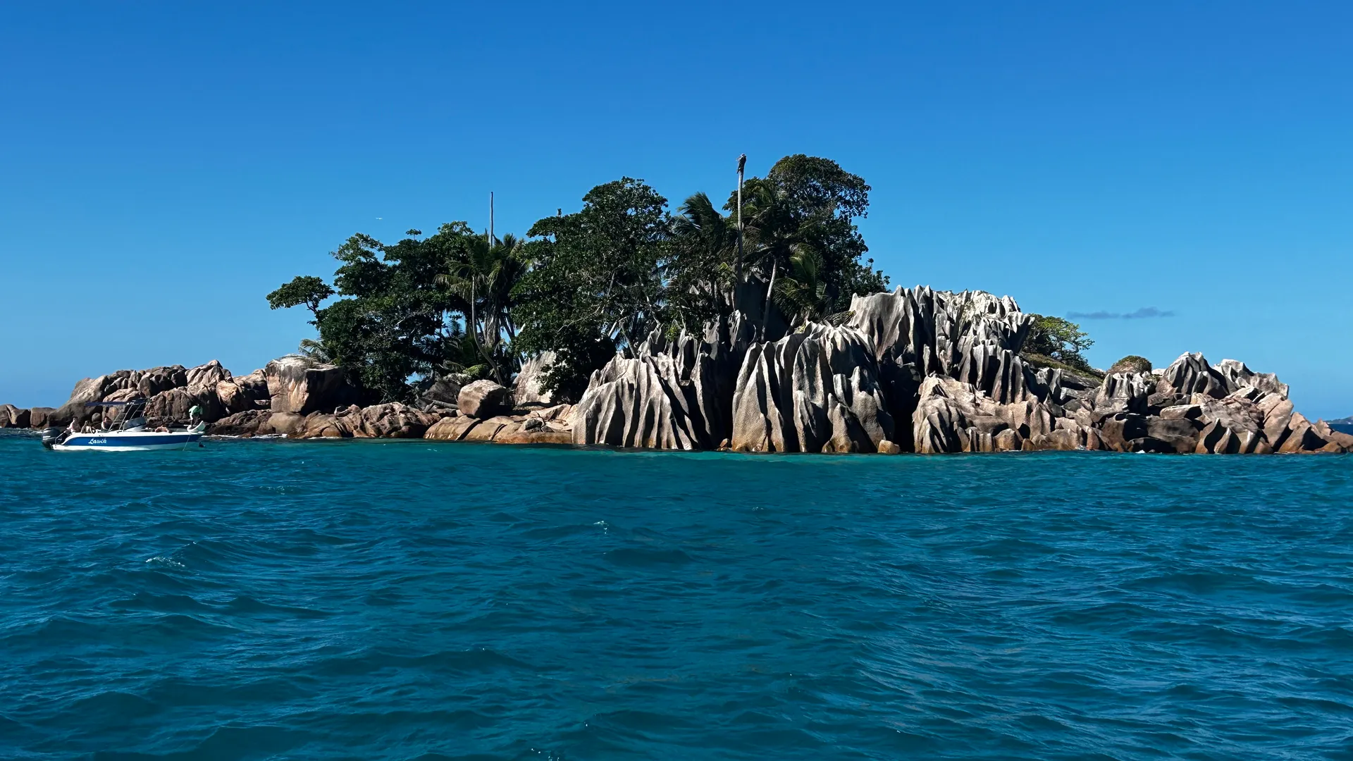 White sand beach with granite boulders and turquoise water, Praslin