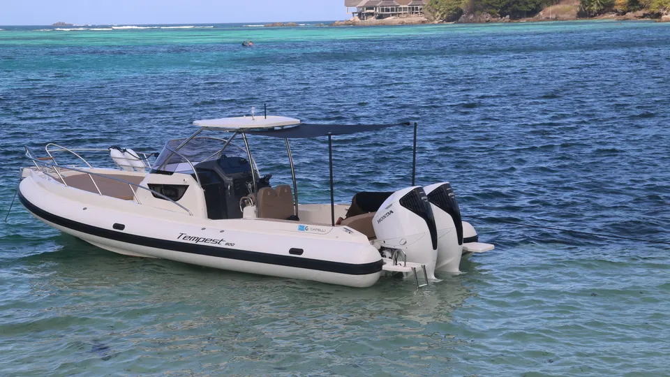 The AUREA I anchored off a sandbar in shallow turquoise water